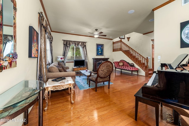 living room featuring ornamental molding, hardwood / wood-style floors, and ceiling fan