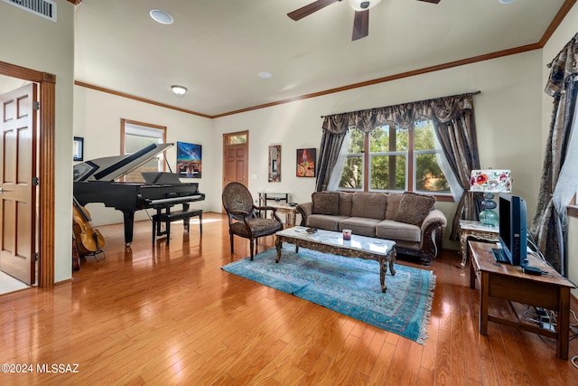 living room with ceiling fan, hardwood / wood-style flooring, and crown molding