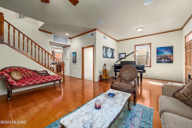 living room featuring crown molding, ceiling fan, and hardwood / wood-style floors