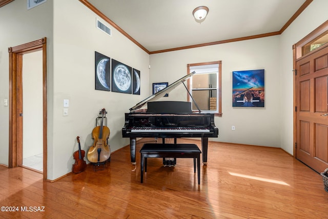 misc room with hardwood / wood-style floors and ornamental molding