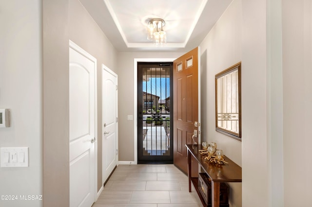 entryway with a raised ceiling