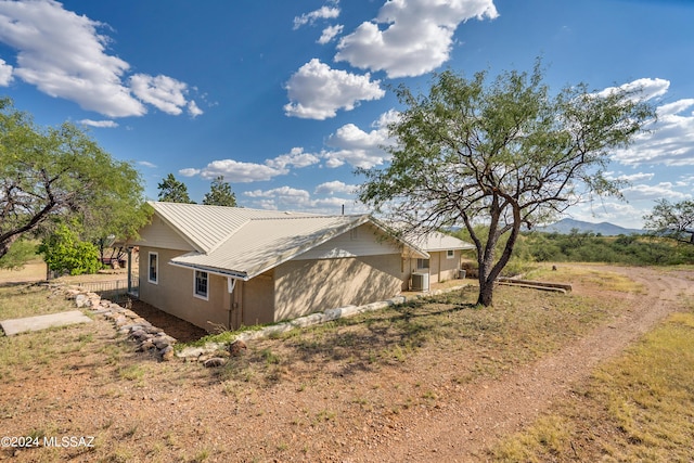 view of home's exterior featuring a yard and a mountain view