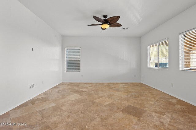 unfurnished room with ceiling fan