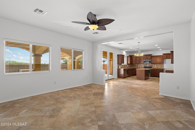 unfurnished living room with ceiling fan