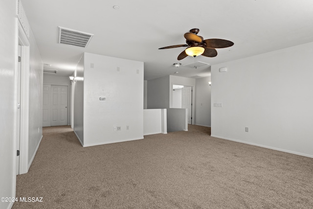 spare room featuring ceiling fan and light carpet