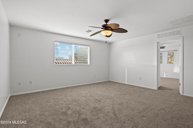 carpeted empty room featuring ceiling fan