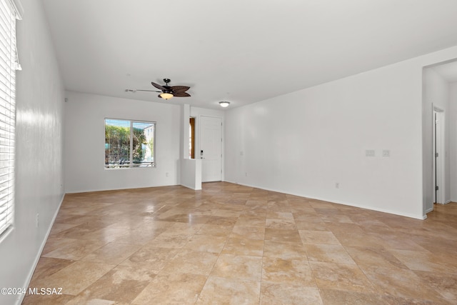 unfurnished living room with ceiling fan