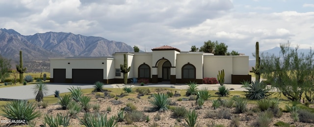 view of front of house featuring a mountain view and a garage