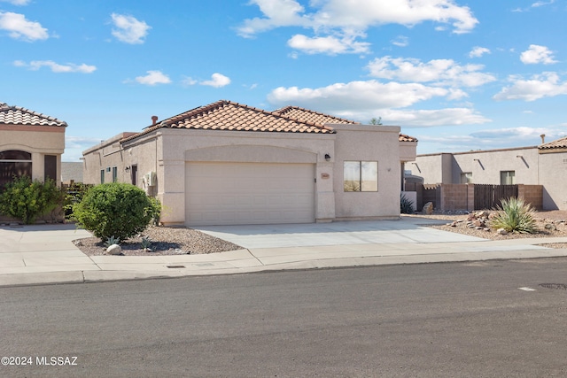 mediterranean / spanish-style home with a garage