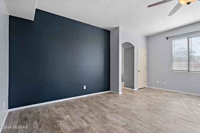 spare room featuring ceiling fan and light hardwood / wood-style flooring