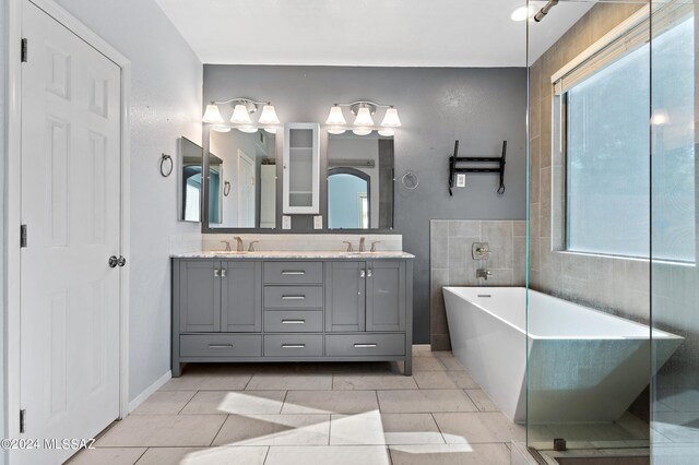 bathroom featuring vanity, a bathtub, and tile patterned floors