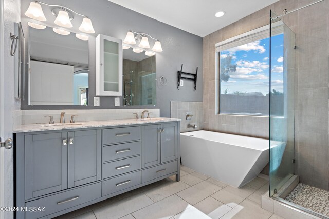 bathroom featuring tile walls, tile patterned flooring, vanity, and plus walk in shower