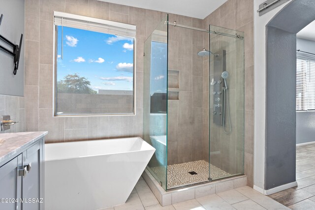 bathroom featuring independent shower and bath, vanity, and hardwood / wood-style floors