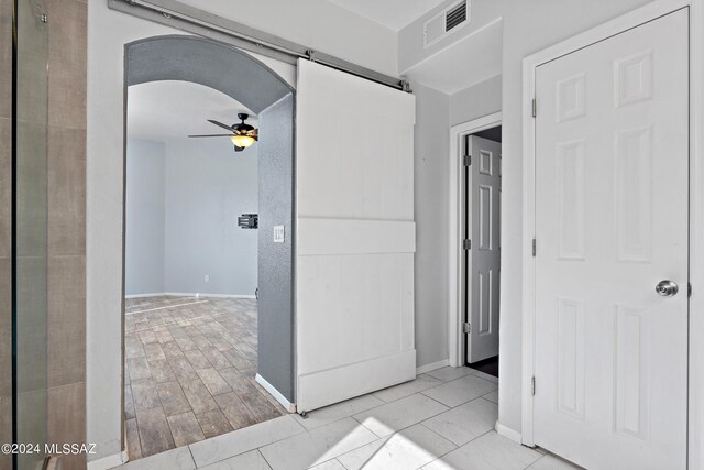 interior space with a barn door and light hardwood / wood-style floors