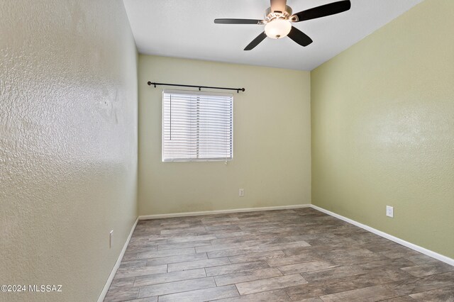 spare room featuring ceiling fan and hardwood / wood-style floors