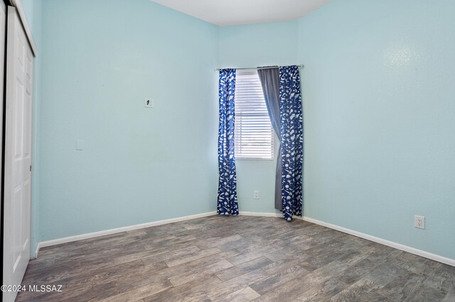 empty room featuring wood-type flooring