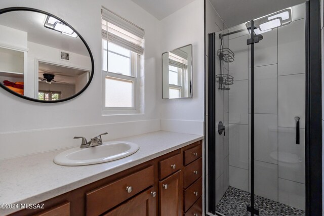 bathroom with vanity and a shower with door