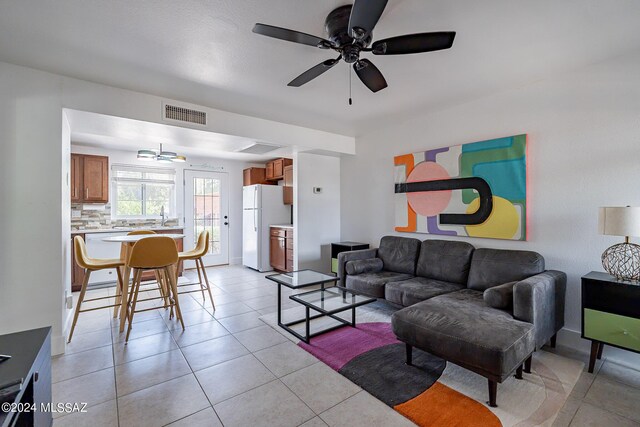 tiled living room with sink and ceiling fan