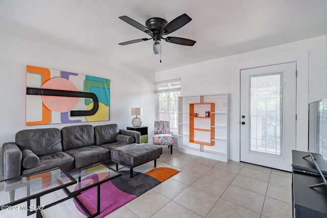 tiled living room with ceiling fan