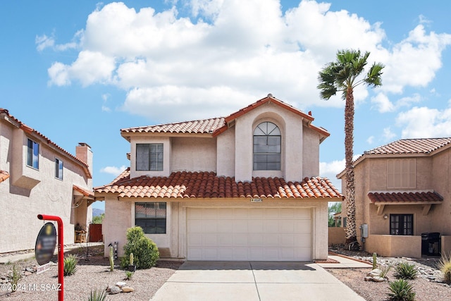 mediterranean / spanish house featuring a garage