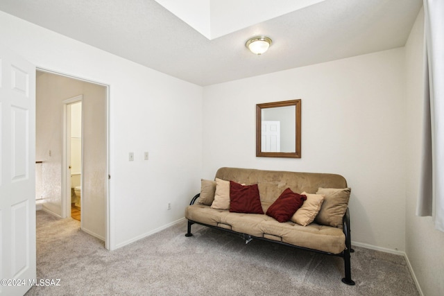 living area featuring light carpet