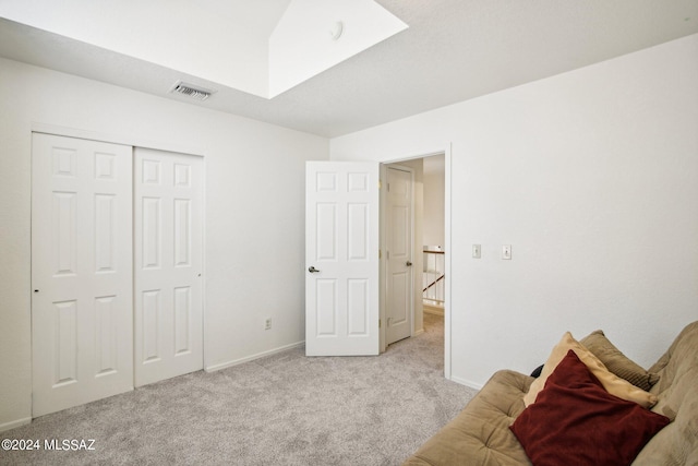 unfurnished bedroom featuring a closet and light colored carpet