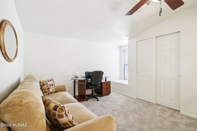 office with vaulted ceiling, ceiling fan, light colored carpet, and a textured ceiling