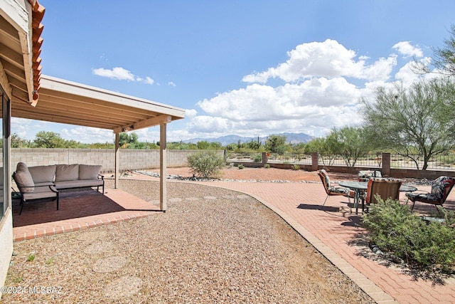 view of yard with a mountain view, outdoor lounge area, and a patio area