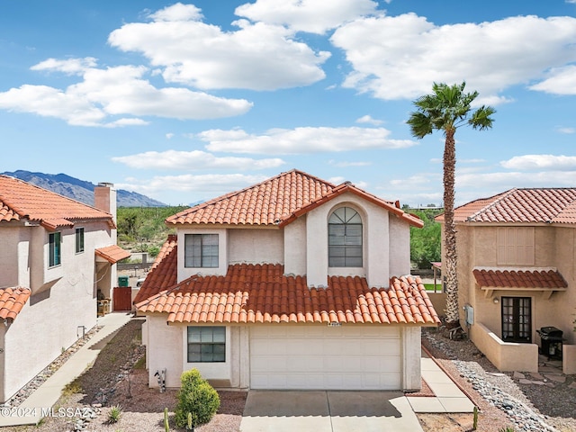 mediterranean / spanish-style home featuring a mountain view and a garage