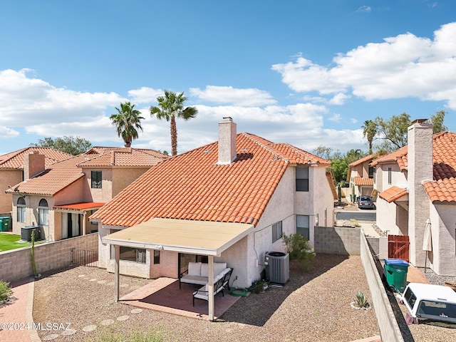 rear view of house featuring central AC and a patio area