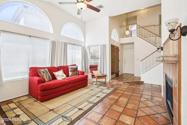 living room featuring ceiling fan, high vaulted ceiling, and tile patterned floors