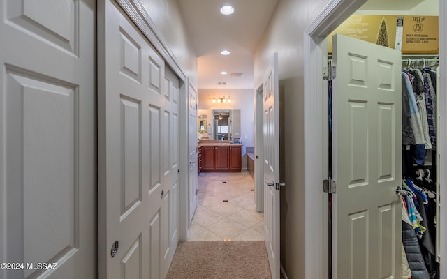 hall with light tile patterned floors