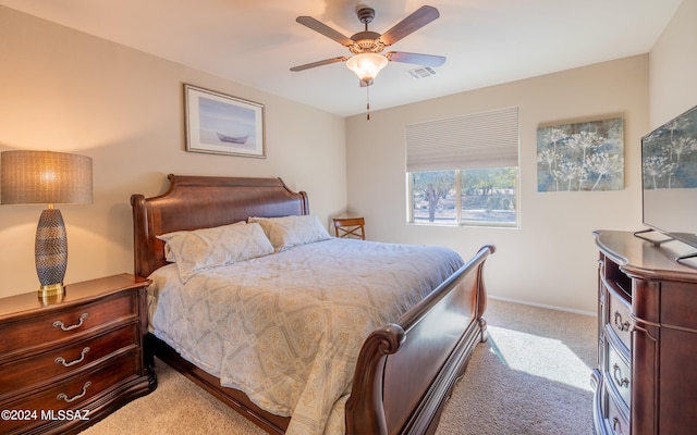 bedroom with ceiling fan and light colored carpet