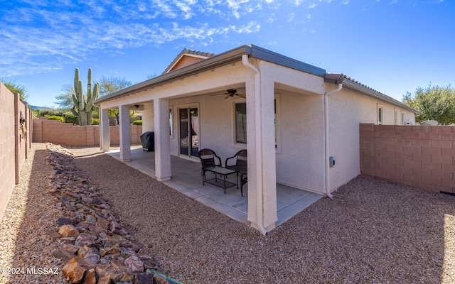 back of property with a patio and ceiling fan