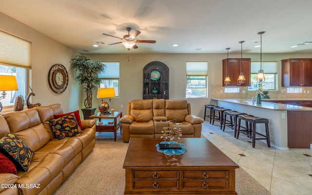 tiled living room featuring ceiling fan