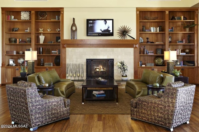 sitting room with a fireplace and hardwood / wood-style floors