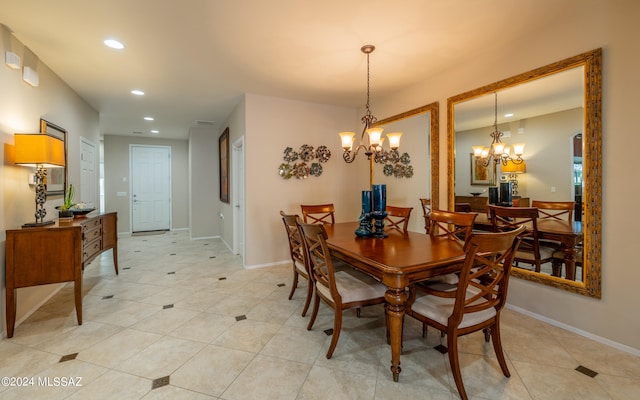 tiled dining room with a notable chandelier