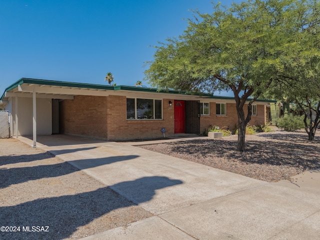 ranch-style home featuring a carport