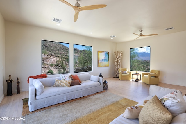 living room with ceiling fan and light hardwood / wood-style floors