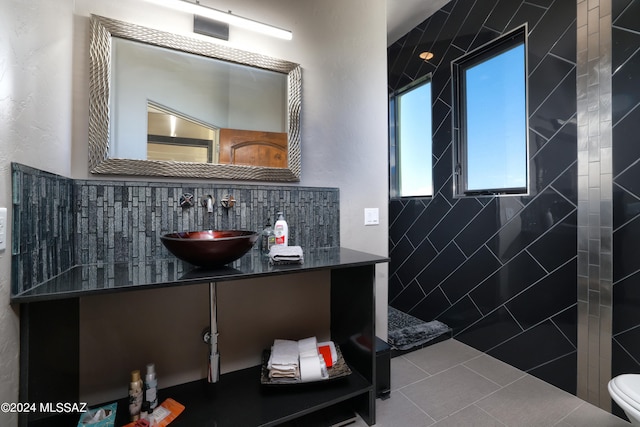 bathroom featuring vanity, toilet, tasteful backsplash, and tile patterned flooring