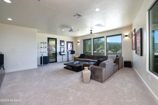 living room with carpet flooring and ceiling fan