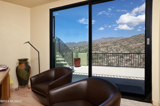 living area featuring a mountain view and hardwood / wood-style flooring