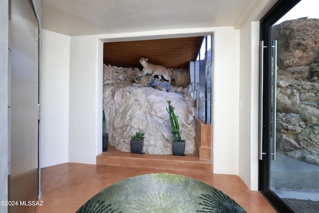 bedroom featuring a textured ceiling and concrete flooring