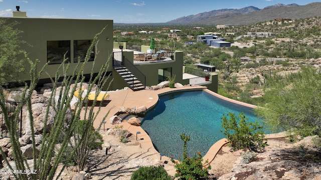 view of swimming pool featuring a mountain view