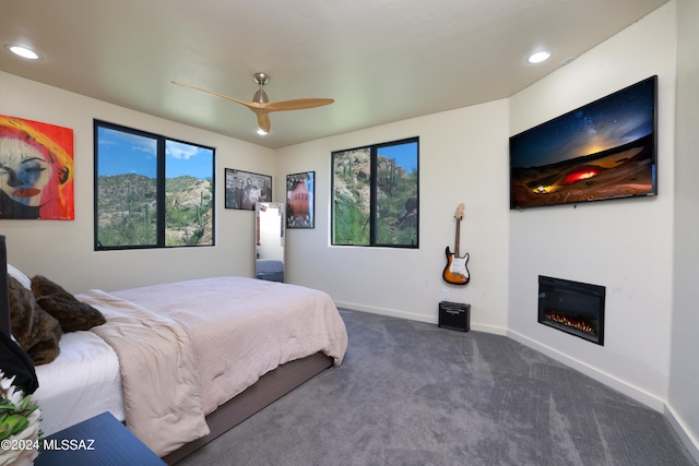 bedroom with dark carpet and ceiling fan