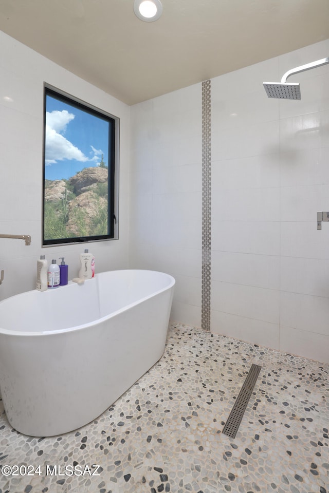 bathroom featuring plus walk in shower and tile patterned floors