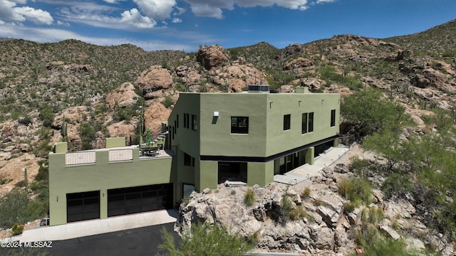 exterior space featuring a balcony and a mountain view