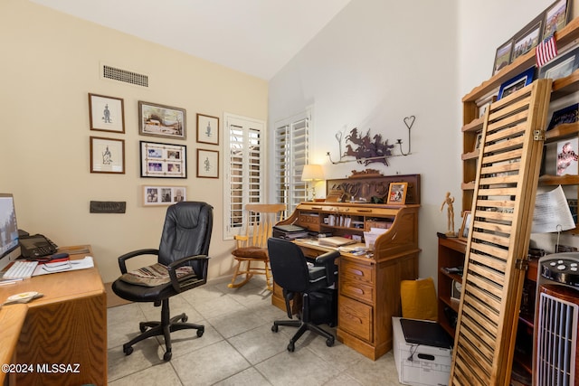 home office with vaulted ceiling and light tile patterned floors