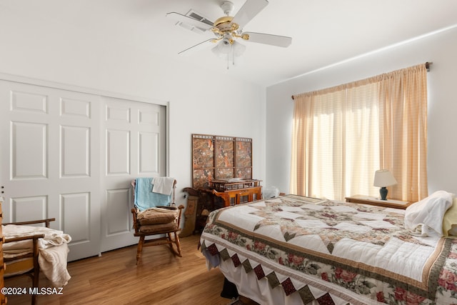 bedroom with a closet, wood-type flooring, and ceiling fan