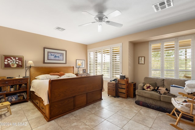 bedroom with ceiling fan, light tile patterned floors, and multiple windows